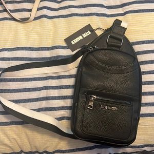 Steve Madden black crossbody bag new with tags. Tiny rip at the bottom